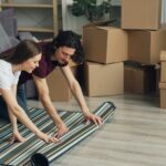 a man and a woman laying on a rug