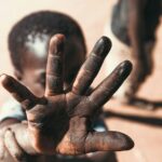 boy with black stain on hand