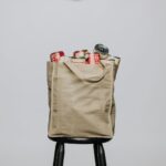 red labeled cans on white fabric handbag