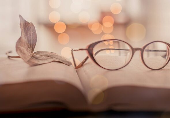 brown framed eyeglasses on book page