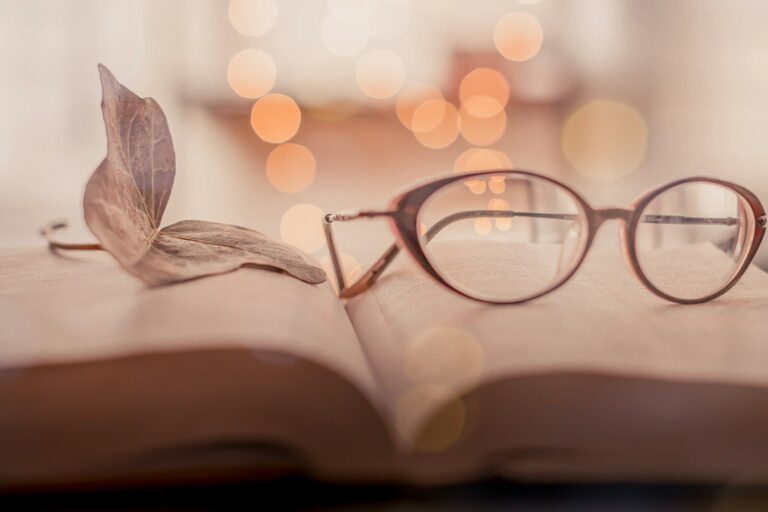 brown framed eyeglasses on book page